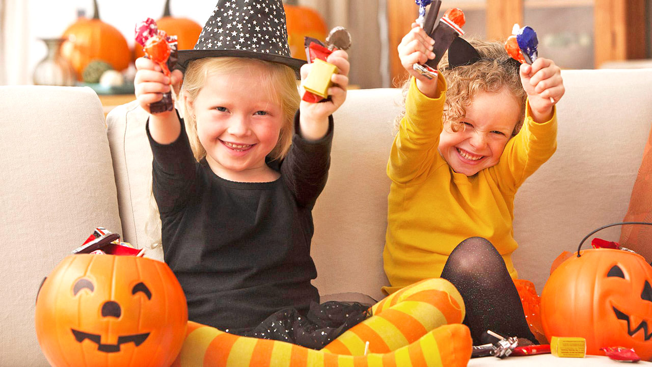Children holding halloween candies