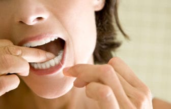 Person flossing between teeth