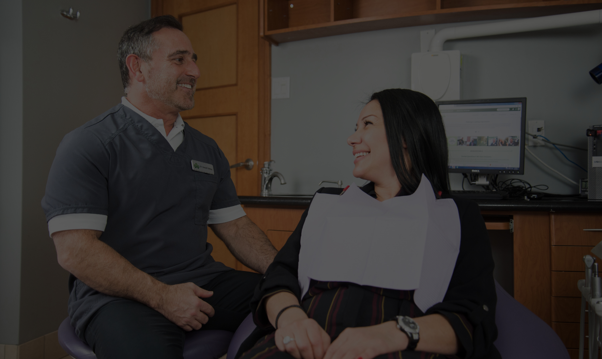 Dentist in Niagara Falls consulting adult patient on procedures